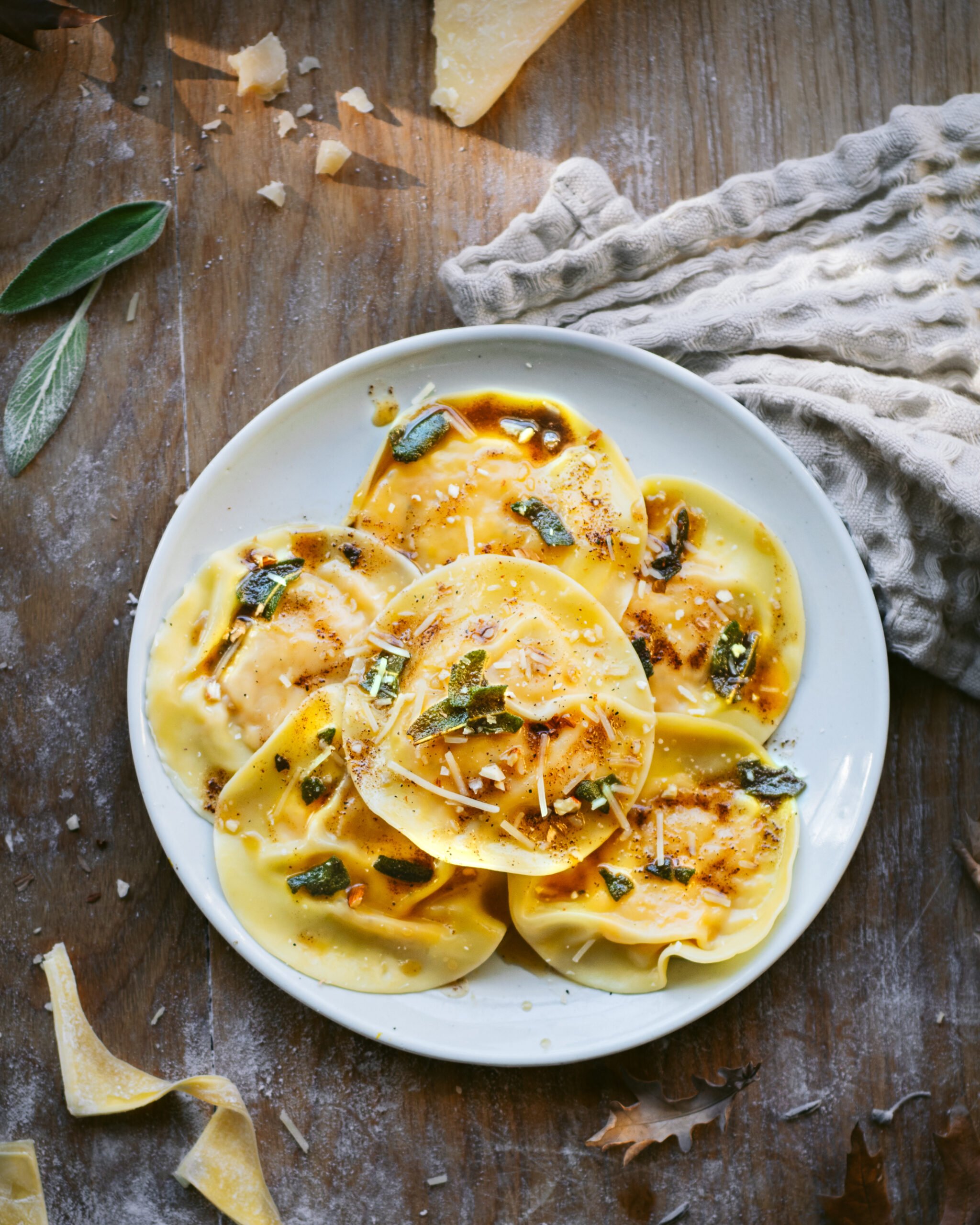 A plate of pumpkin ravioli on a wooden background