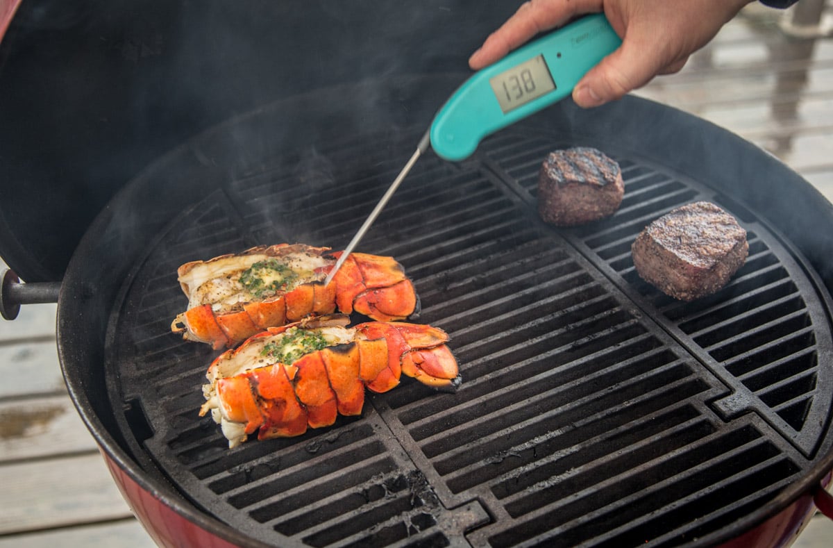 Taking the temperature of grilled lobster with a digital thermometer