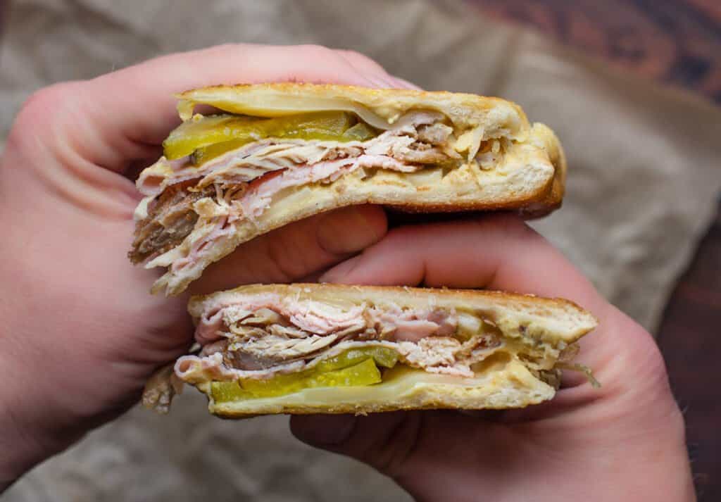 Holding a Cuban Sandwich.