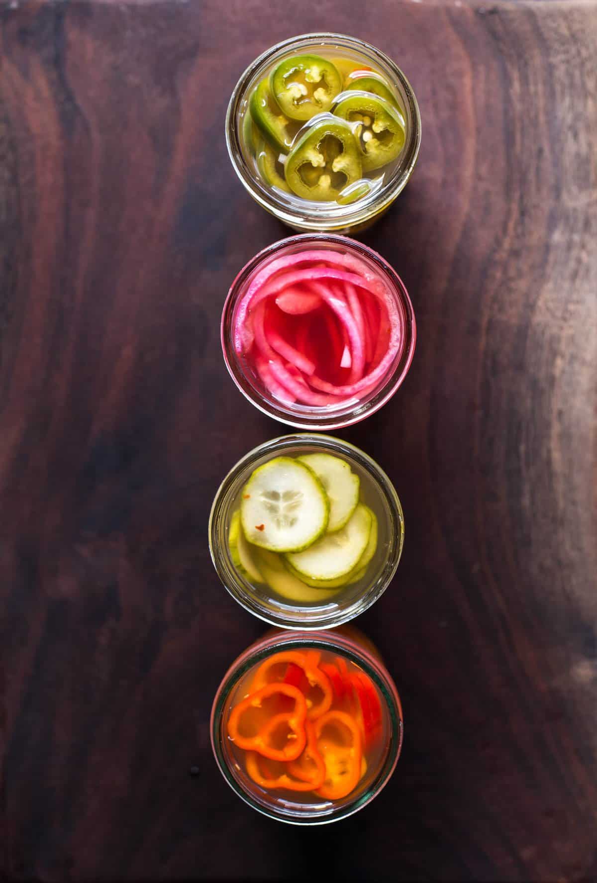 A top down look at 4 jars filled with quick pickled vegetables