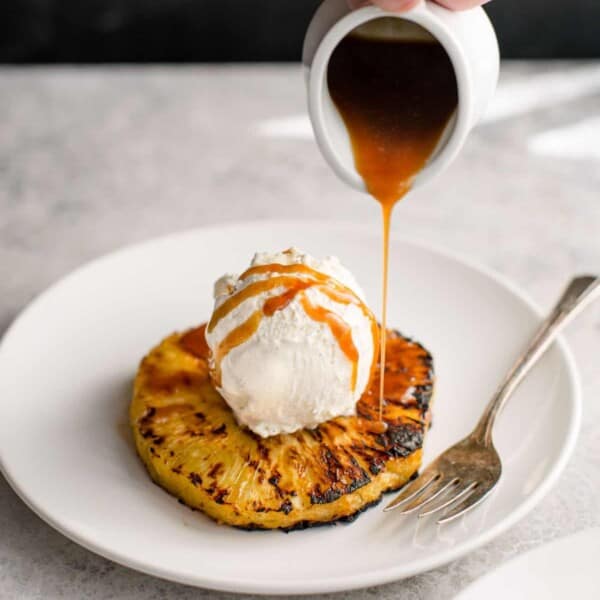 Grilled Rum soaked pineapple topped with ice cream and caramel glaze.