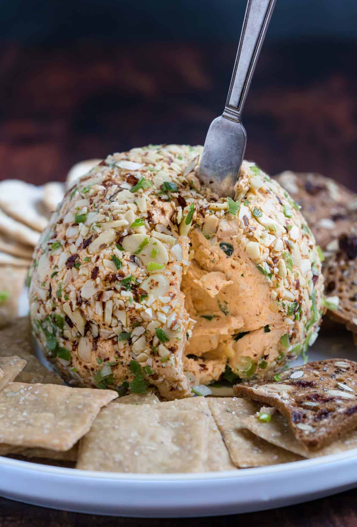 Cheeseball coated with almonds on a platter