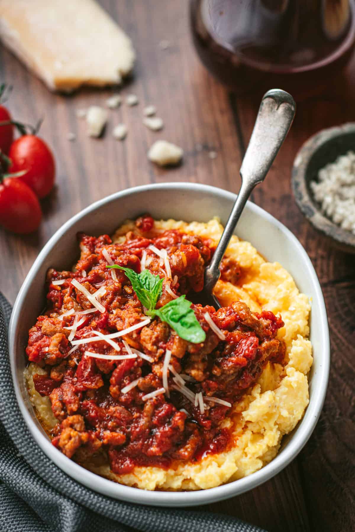 A bowl of smoked sausage ragu over creamy polenta