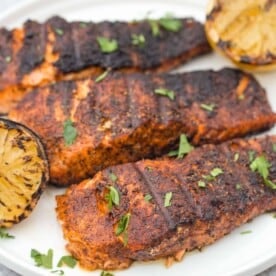 Blackened salmon fillets on a plate.