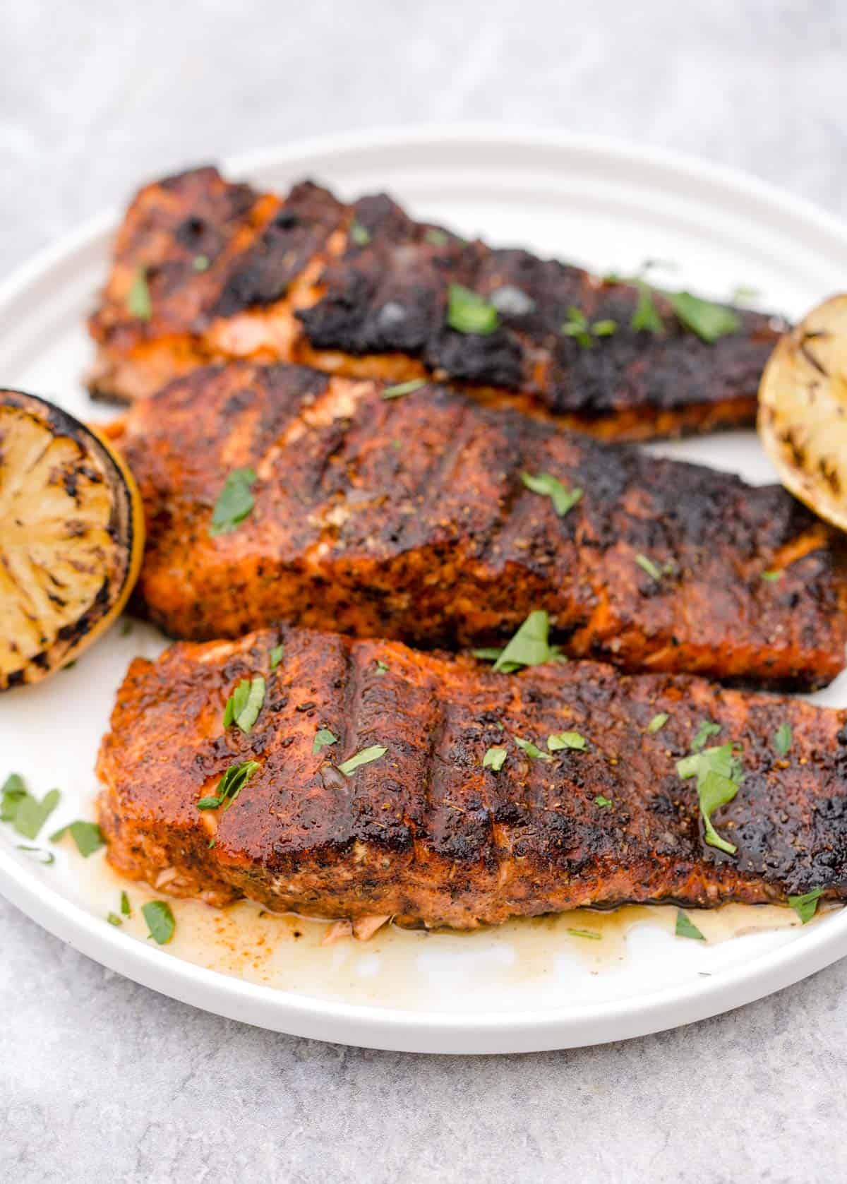 Grilled Blackened Salmon on plate with grilled lemon.