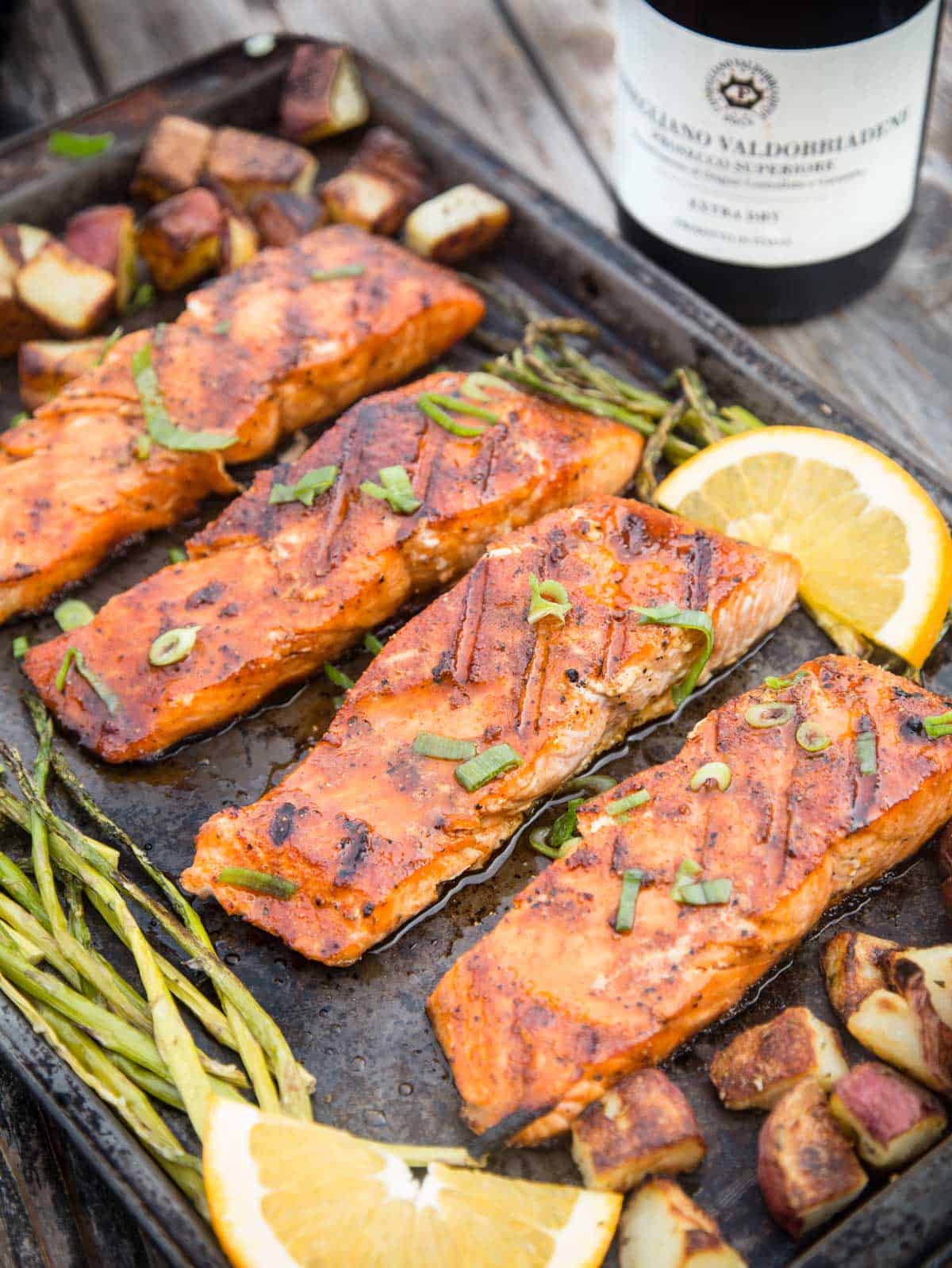 Grilled salmon on a sheet pan with a bottle of Prosecco wine pairing