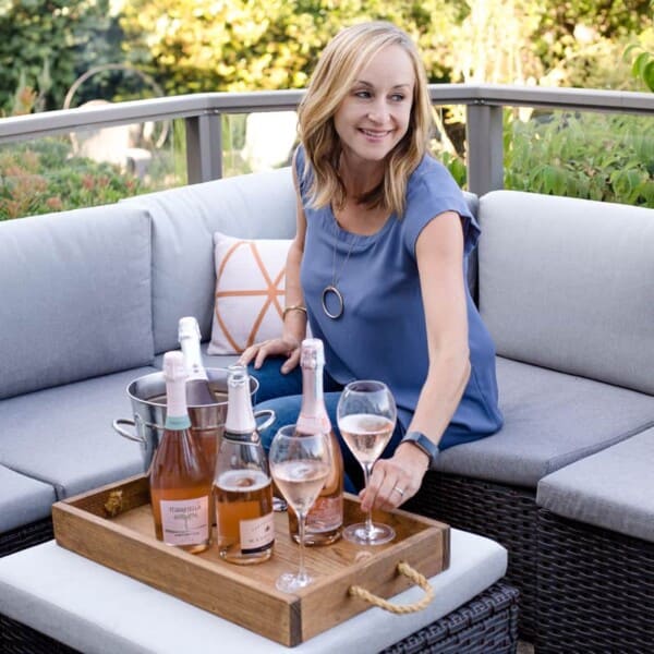 Mary Cressler on a couch with prosecco.