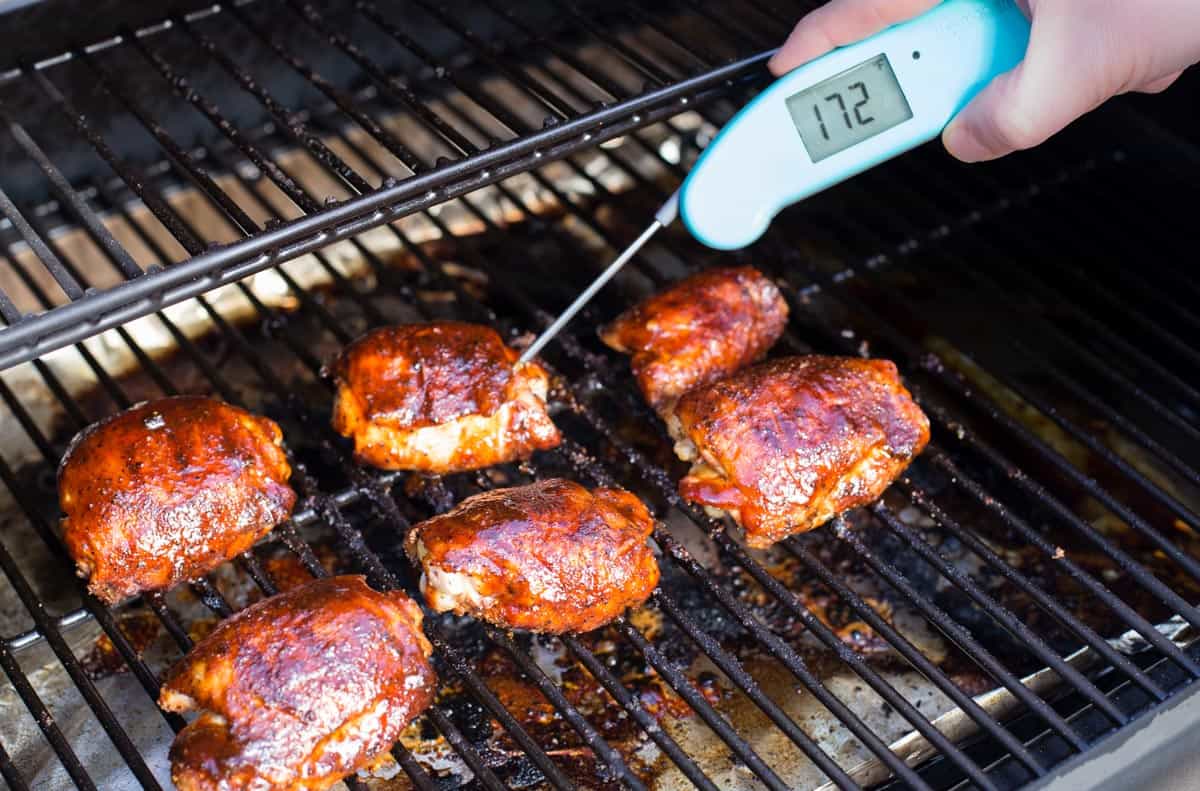 Temperature being taken of chicken thighs with Thermapen.