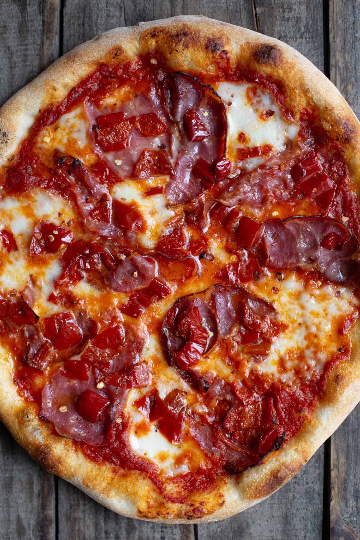 A Neapolitan Style Pizza topped with Soppressata and Coppa and Mama Lil's peppers
