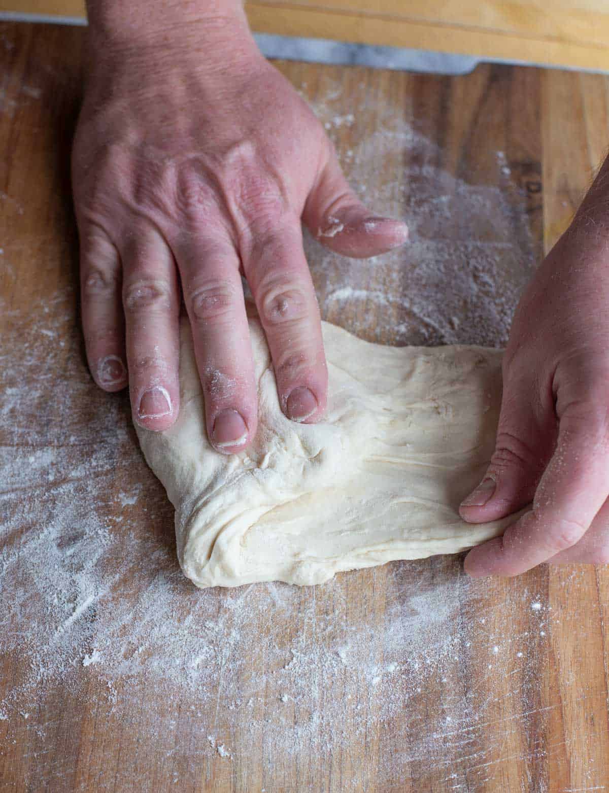 Kneading and folding dough.