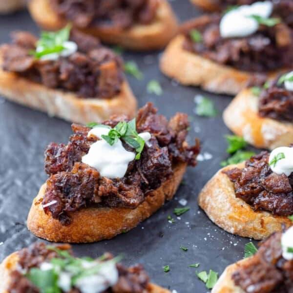 Brisket bruschetta crostini on a serving platter.