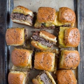 A sheet tray of cheeseburger sliders.