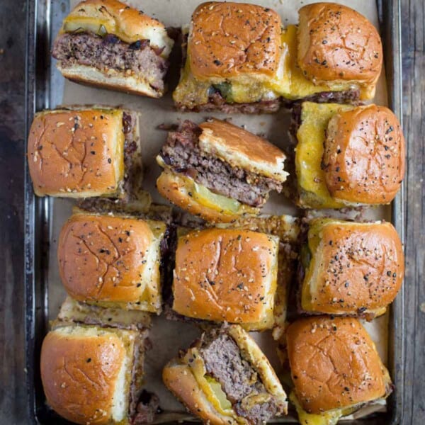 Cheeseburger sliders on a tray.