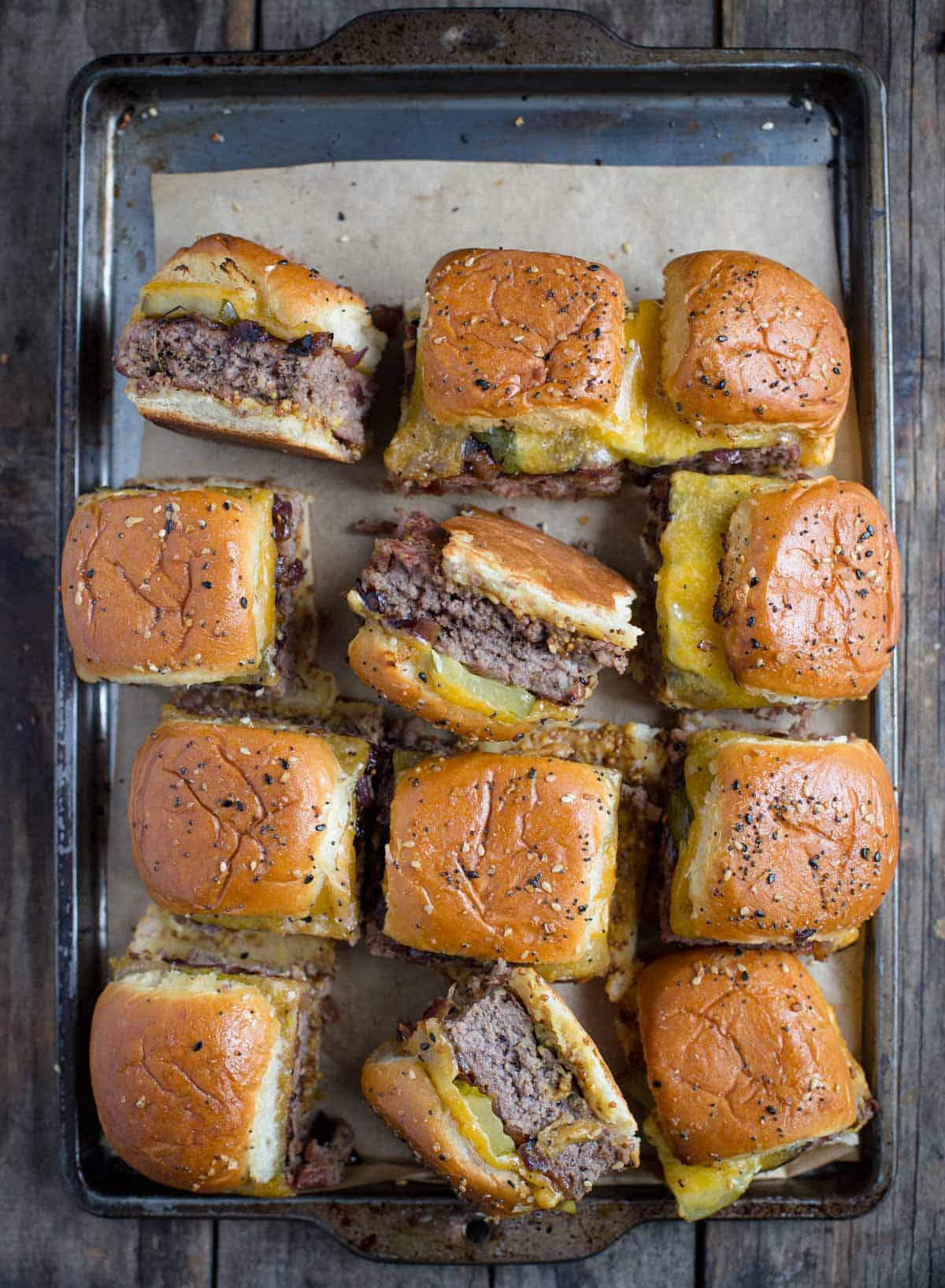 A sheet tray of cheeseburger sliders.