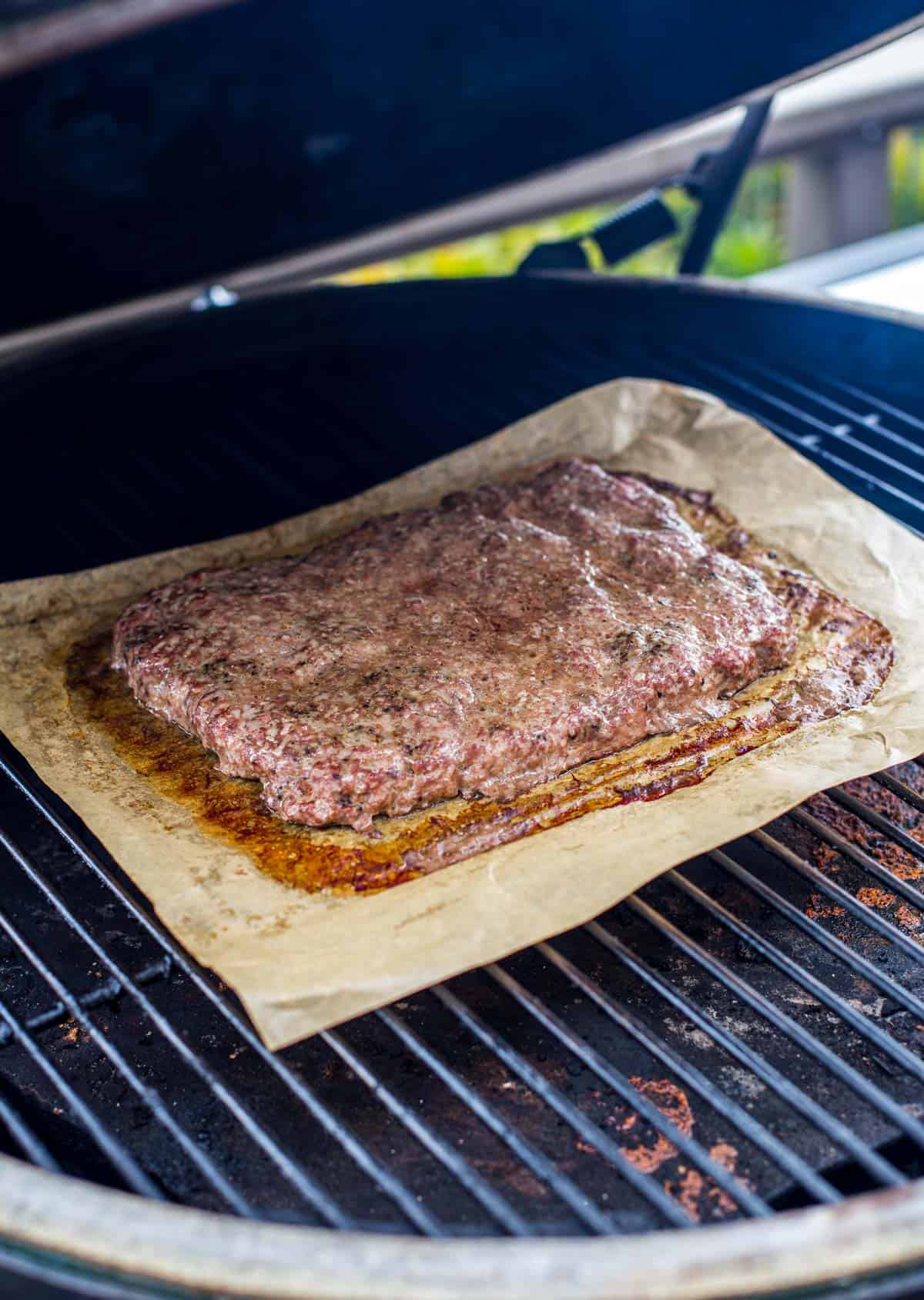 Ground beef patty for sliders on a Big Green Egg Smoker.