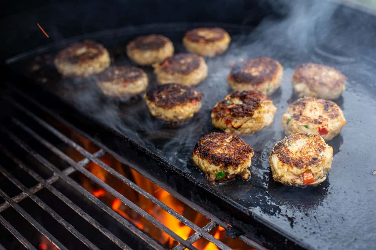 Grilled Crab and Salmon Cakes on a plancha on a Big Green Egg.
