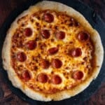 Gluten Free Pizza Dough topped with cheese and pepperoni for a GF pepperoni pizza.