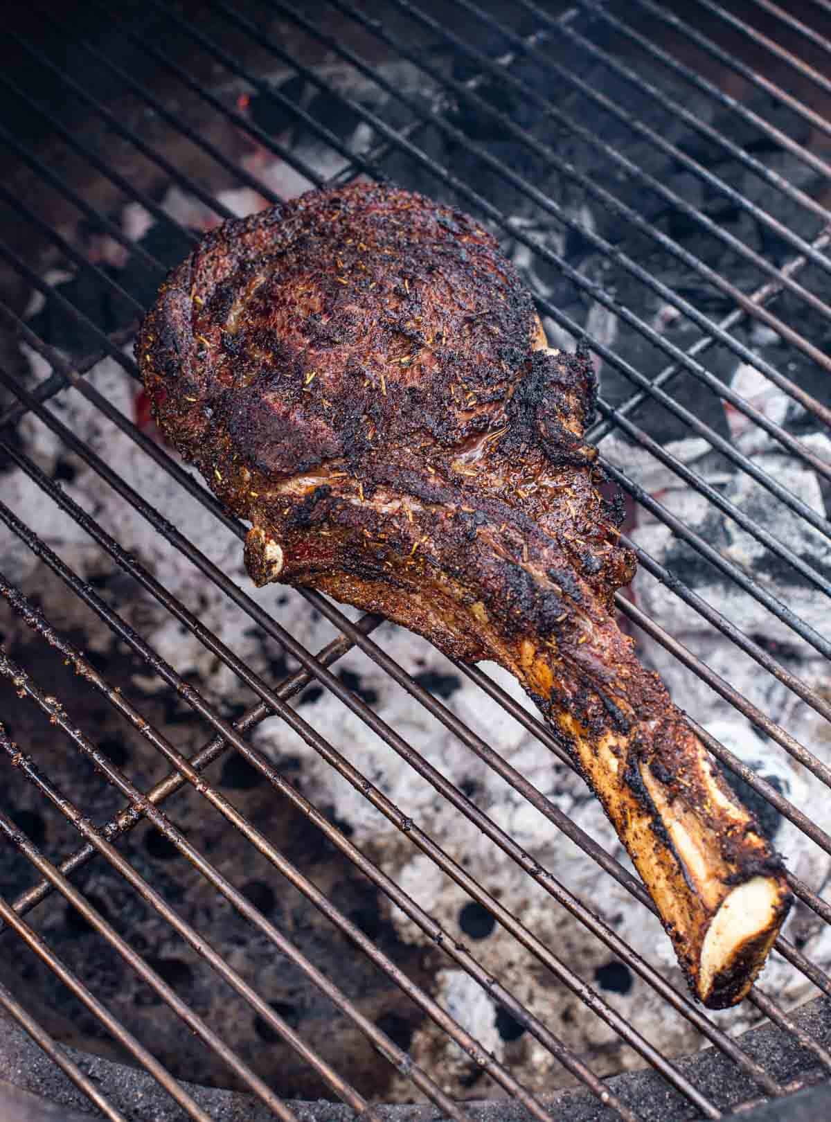 Grilled Tomahawk steak over indirect heat.
