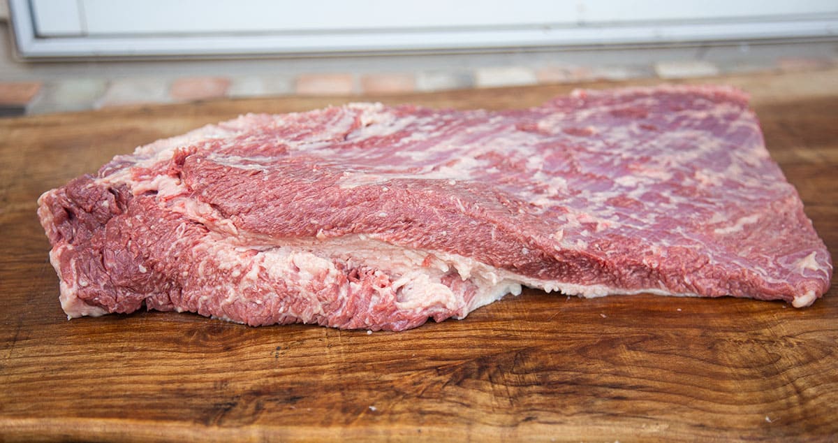 a raw brisket trimmed of fat and ready for smoking