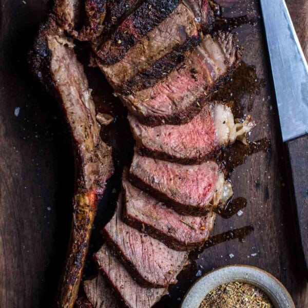 Sliced Tomahawk Steak on a cutting board.
