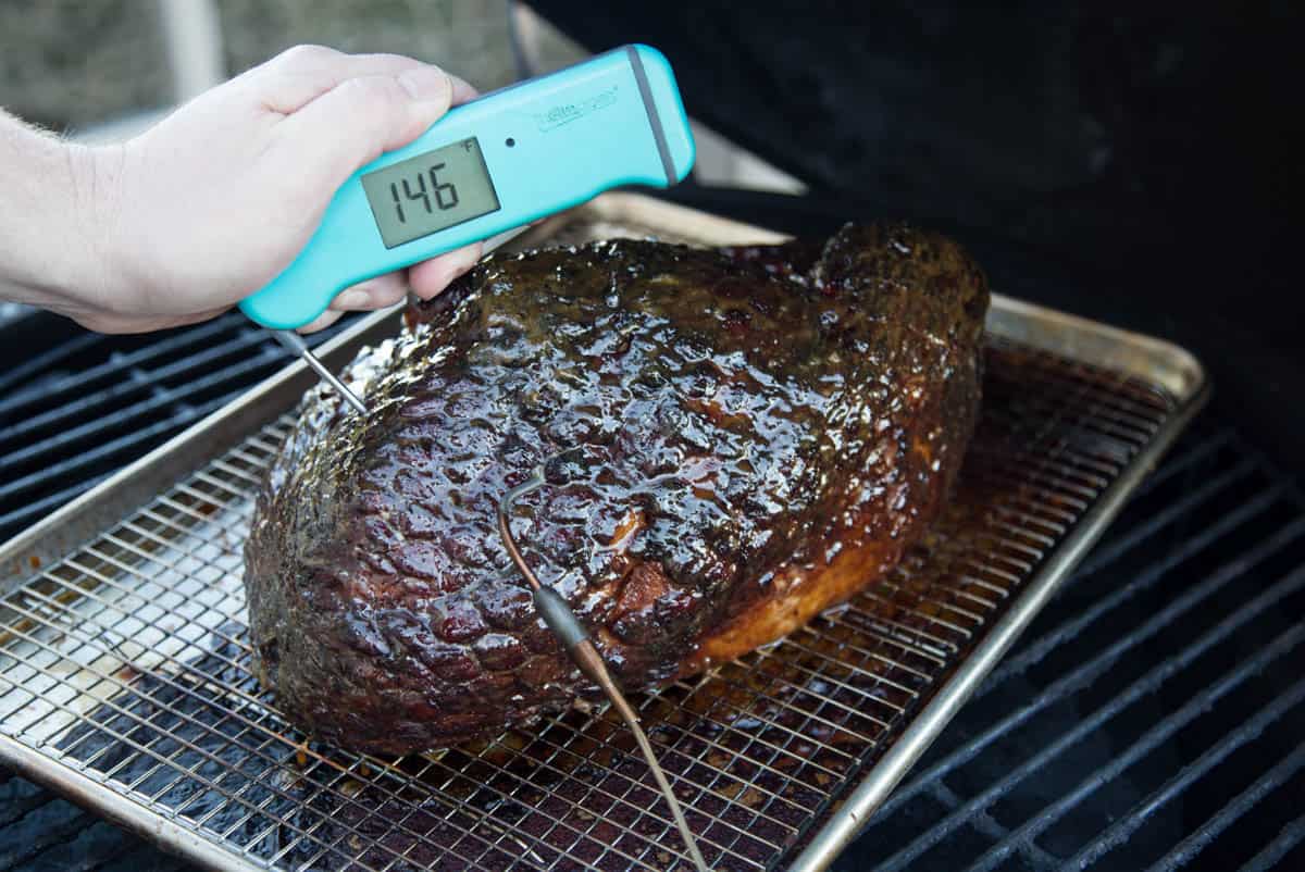 Taking temperature of a smoked ham with a Thermoworks digital thermometer