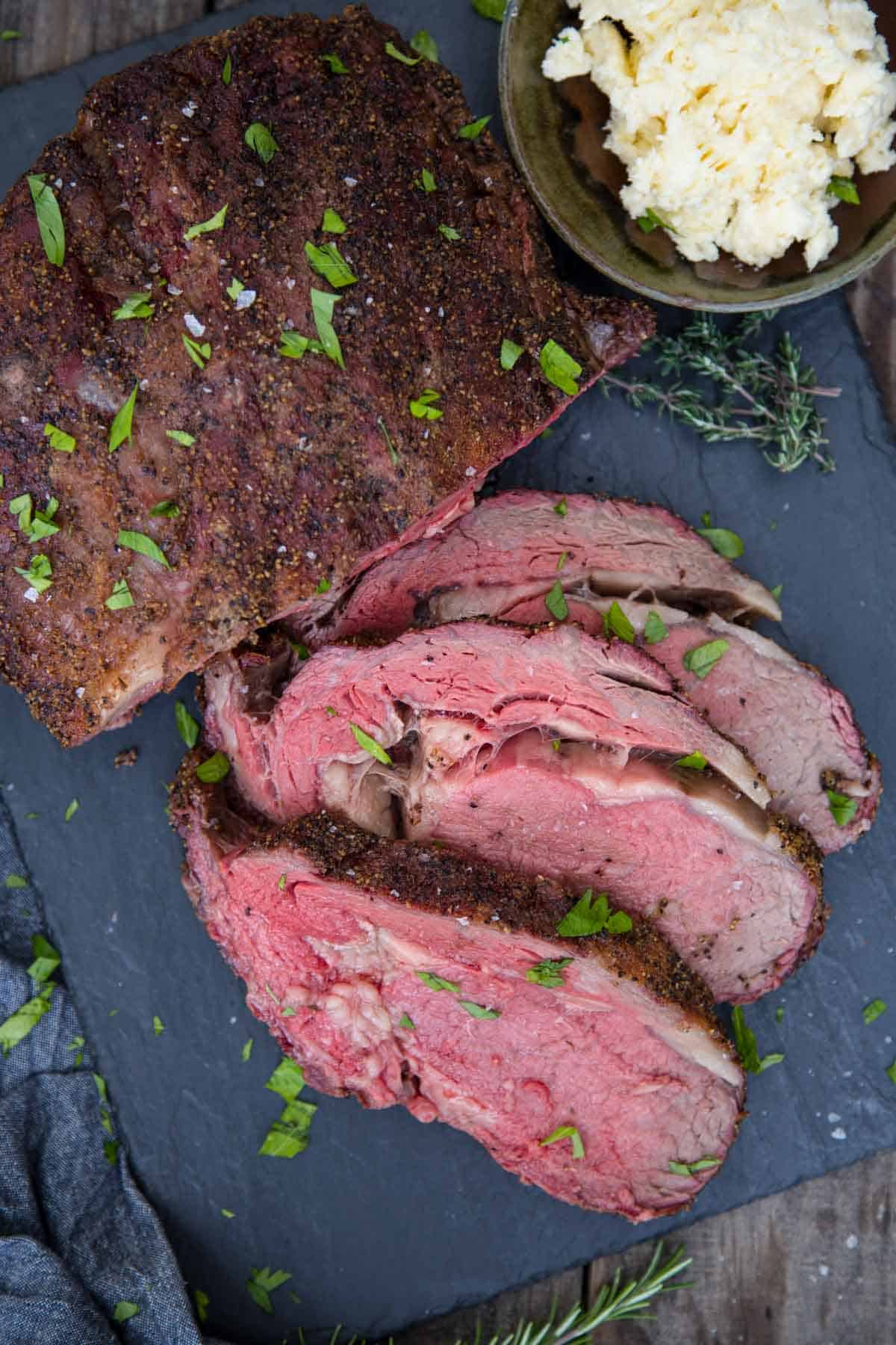 Slices of boneless smoked prime rib on a serving dish