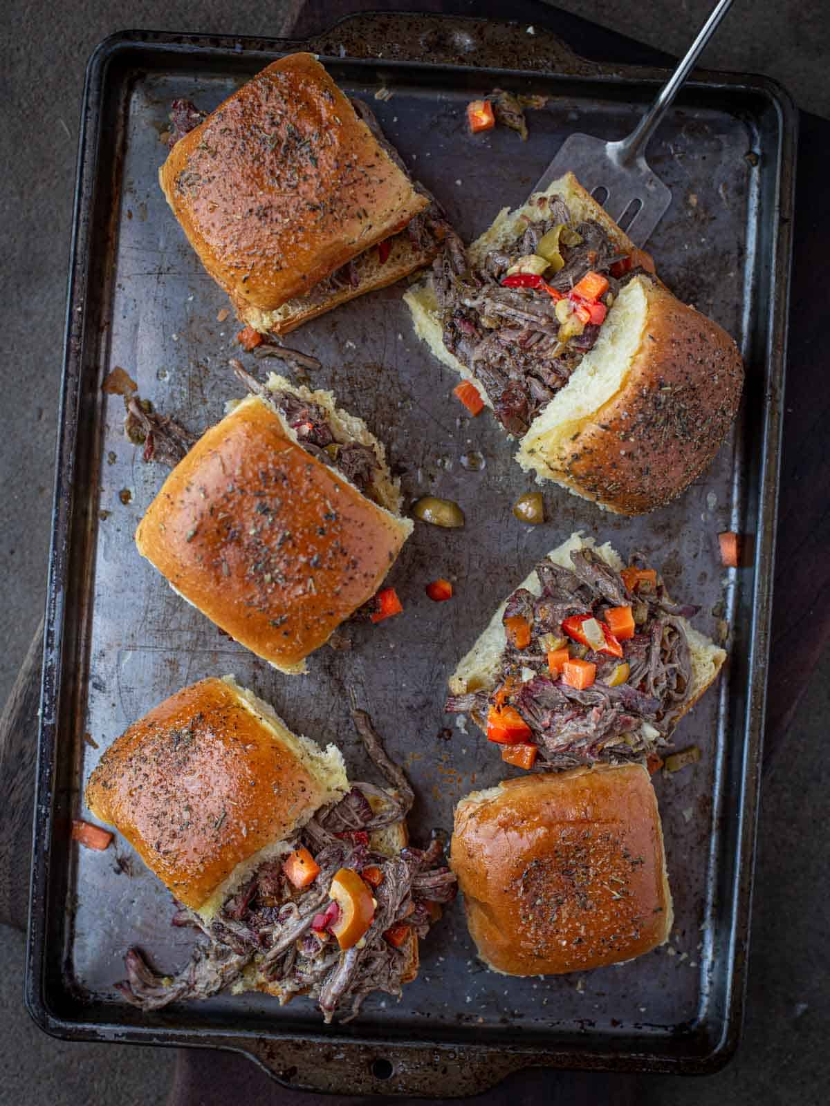 Italian beef sliders on a sheet pan.