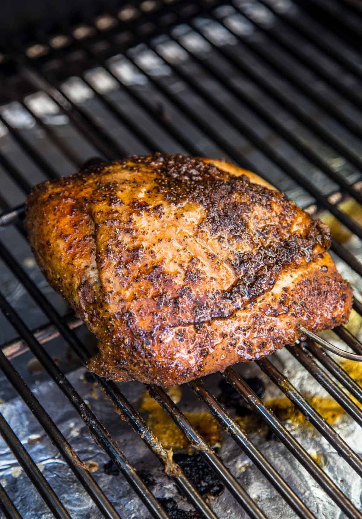 a turkey breast with a maple glaze on a smoker