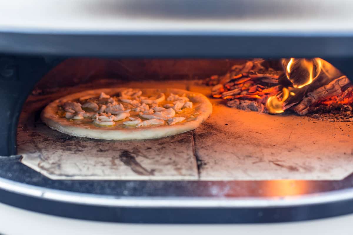 Garlic pizza being cooked in a Gozney Dome.