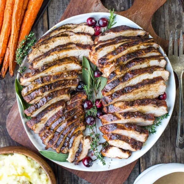 Cajun Grilled Turkey breast slices on a plate with sides.