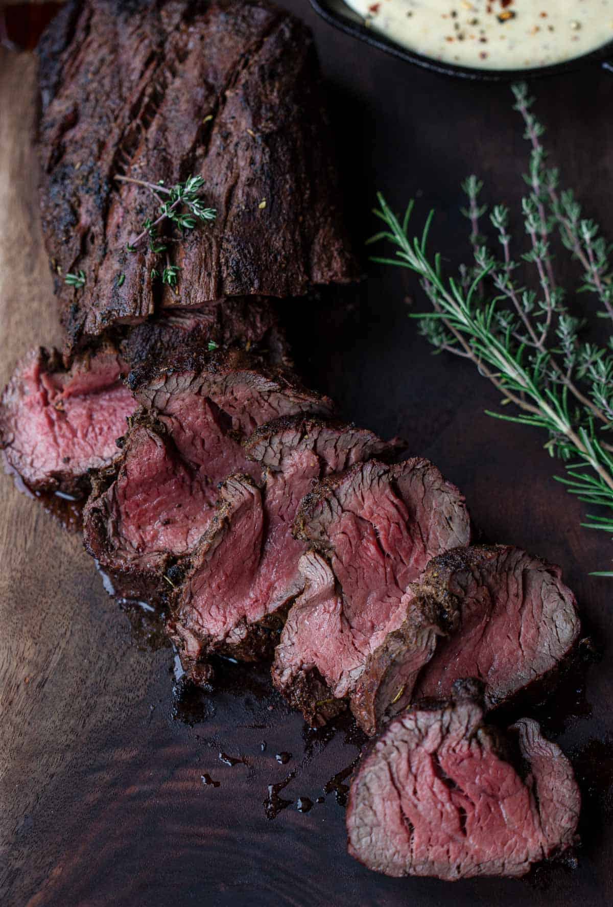 Slices of grilled beef tenderloin on a cutting board