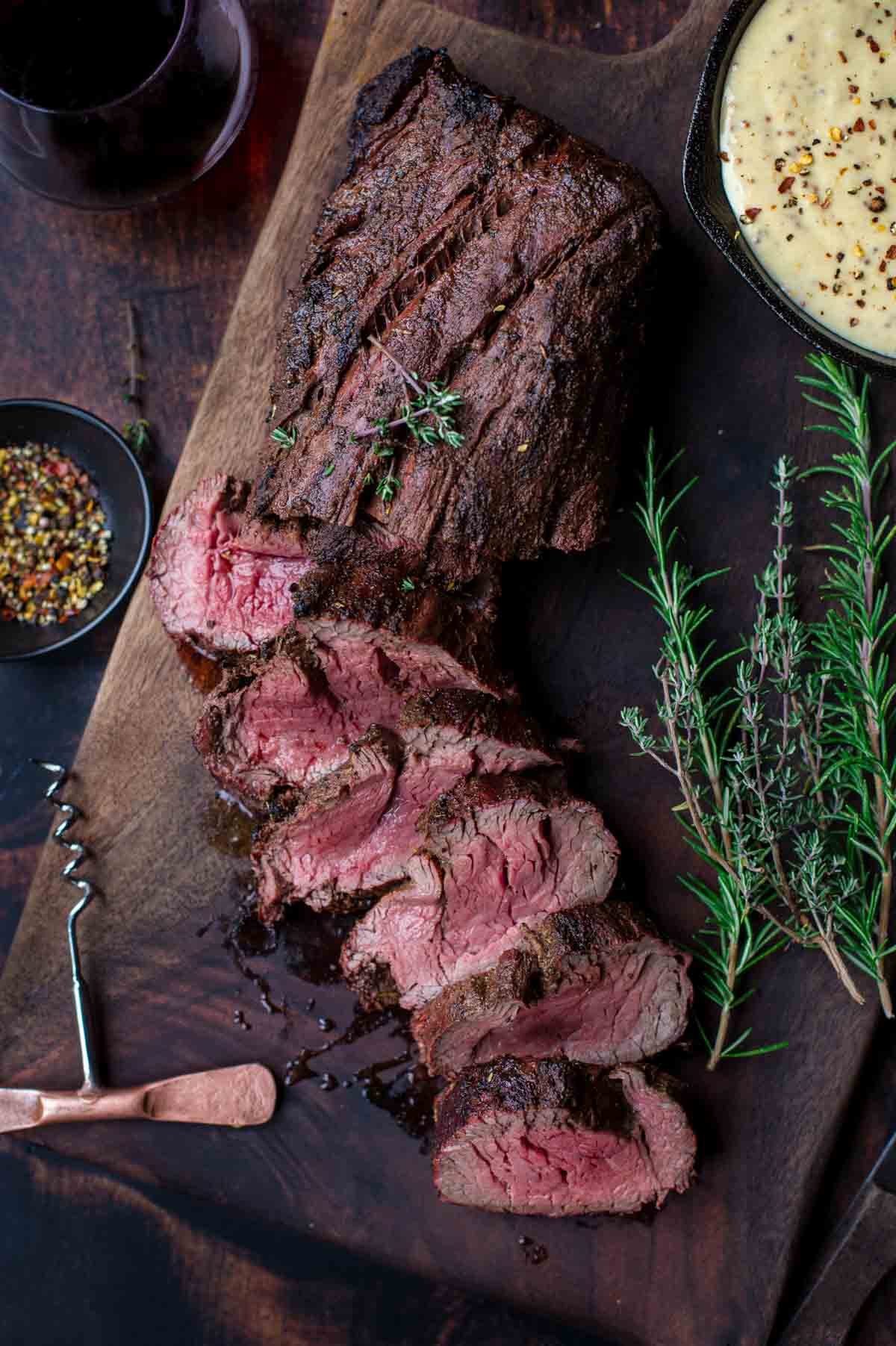 Grilled Beef Tenderloin slices with a mustard steak sauce on a serving platter