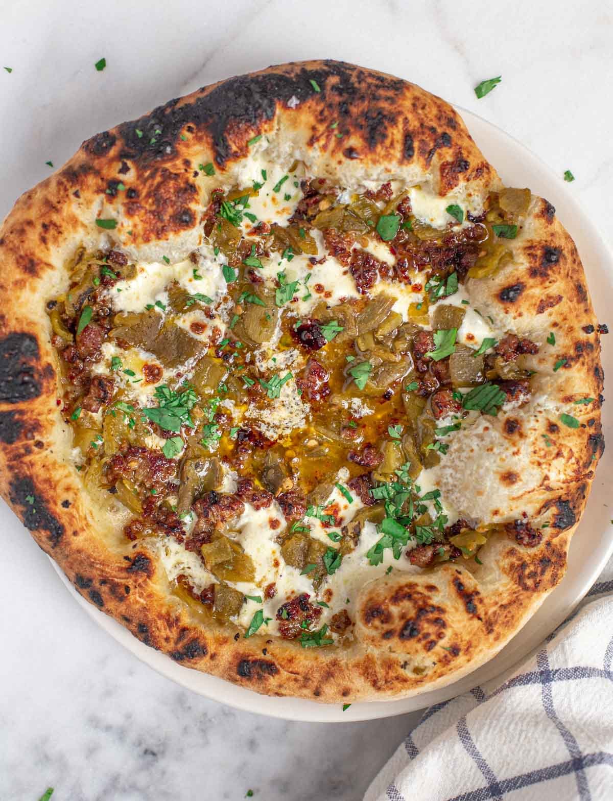 Green Chile Pizza on a wooden board.