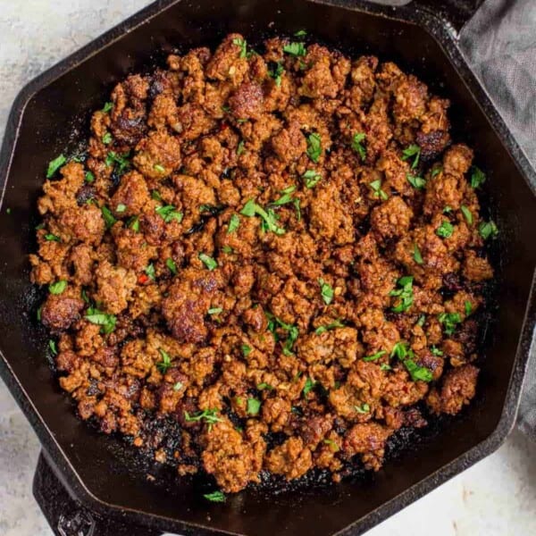 Cooked pork chorizo in a cast iron skillet.