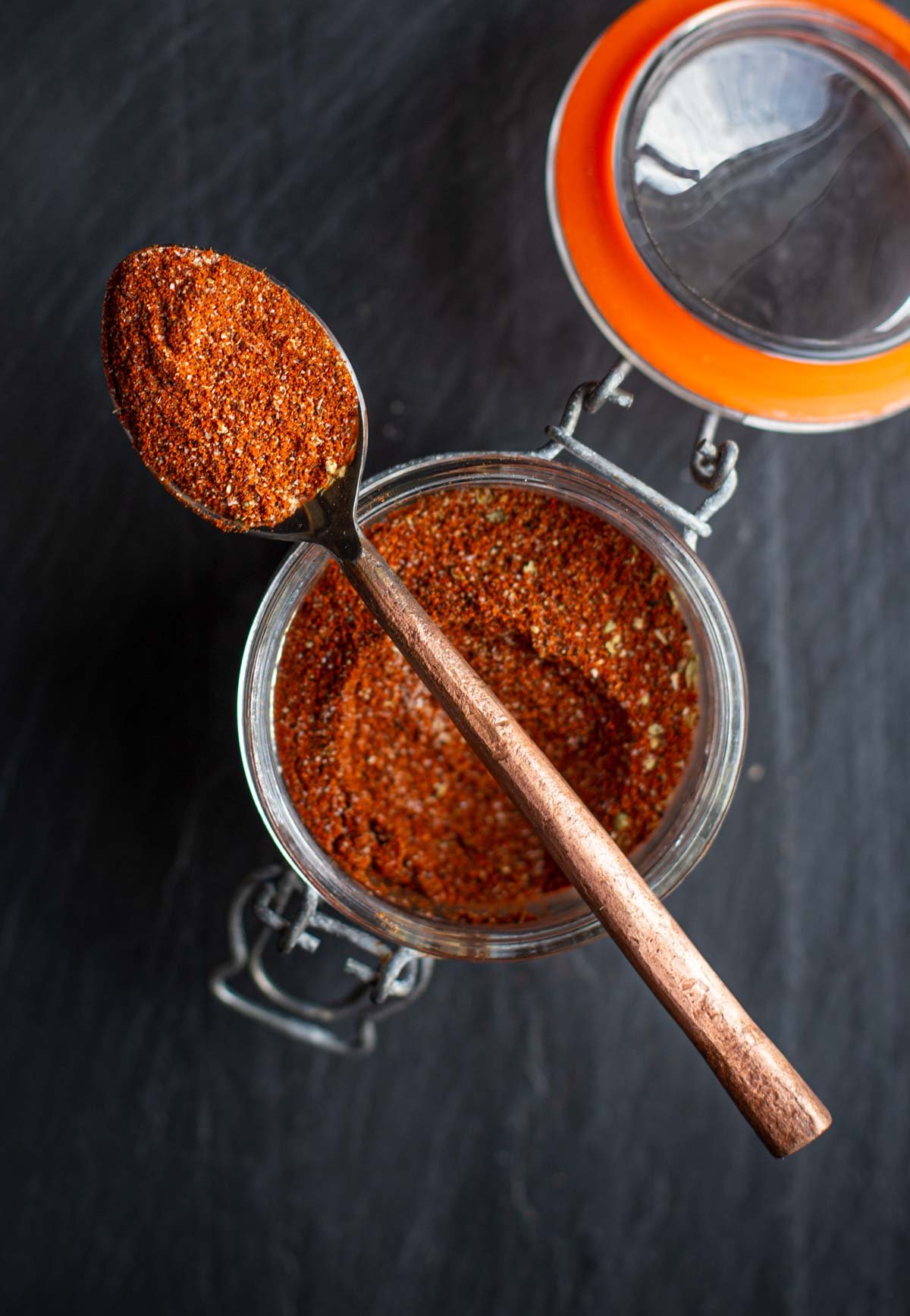 chorizo seasoning on a spoon in a mason jar