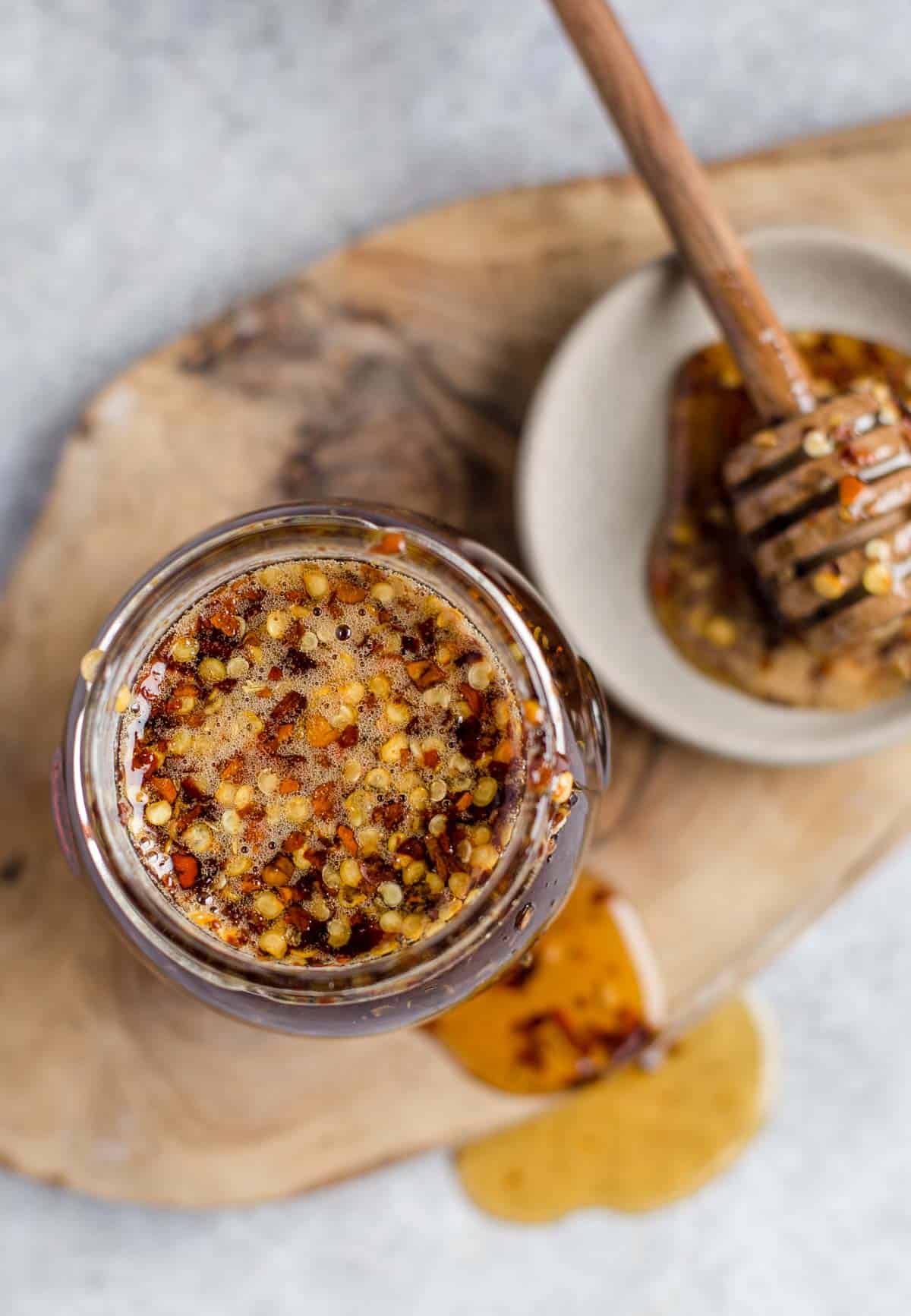 A top down photo of hot honey with chili flakes 