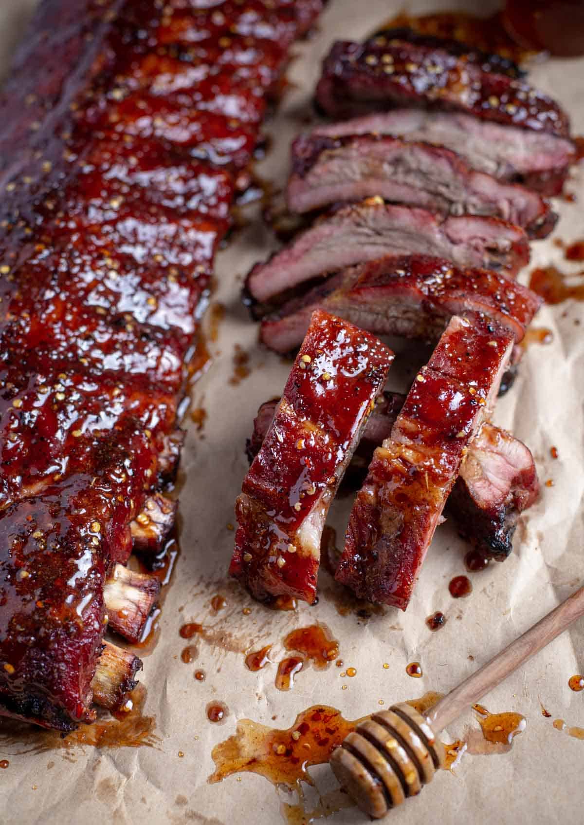 slices of hot honey ribs on butcher paper