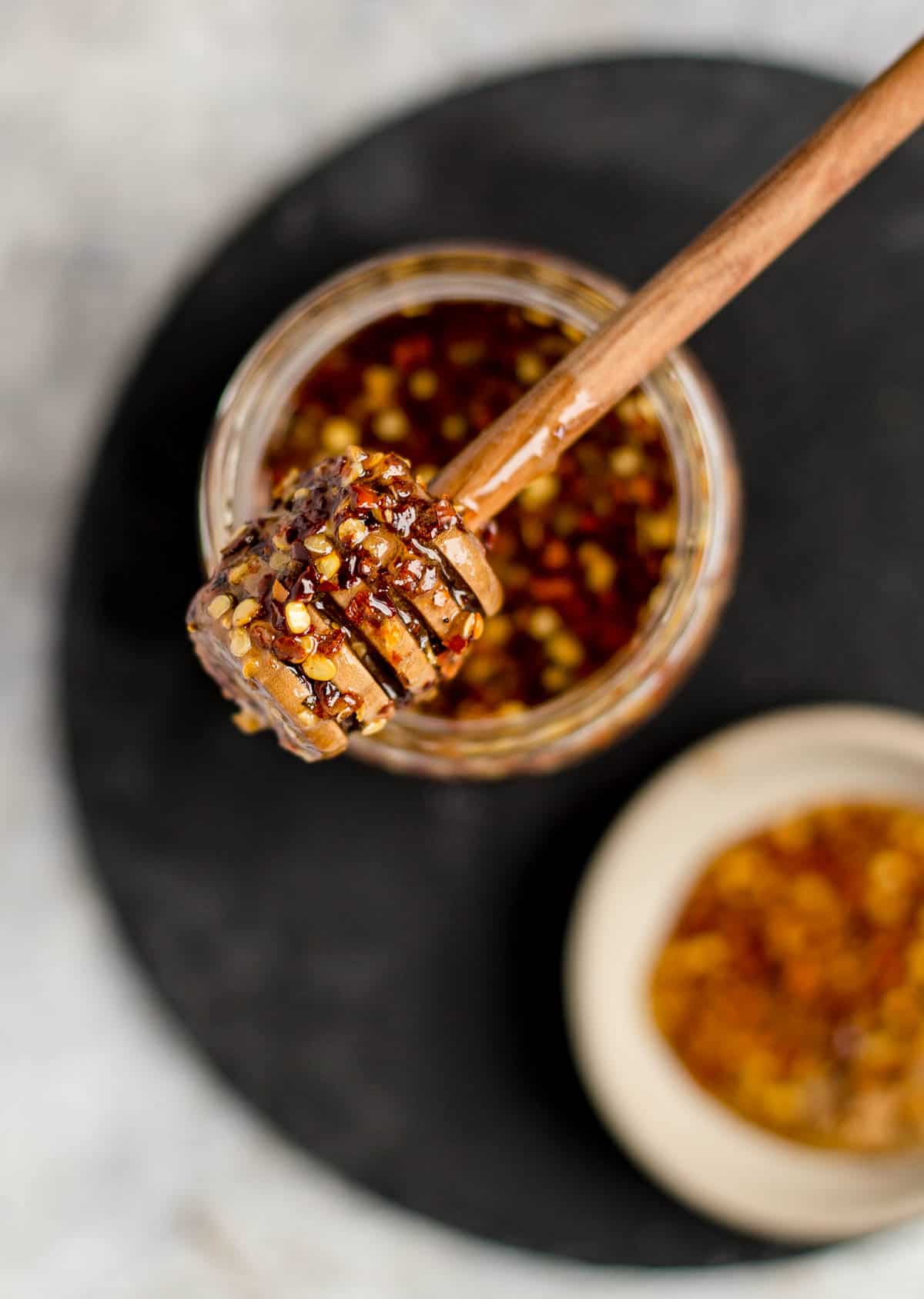 Savory hot honey on a plate in a jar.