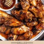 A plate if grilled buffalo wings tossed in a hot honey sauce