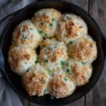 Gluten free drop biscuits in cast iron pan with cheddar and jalapeno.