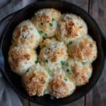 Gluten free drop biscuits in cast iron pan with cheddar and jalapeno.