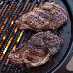 Grilled ribeye steaks on Solo Stove Grill grate.