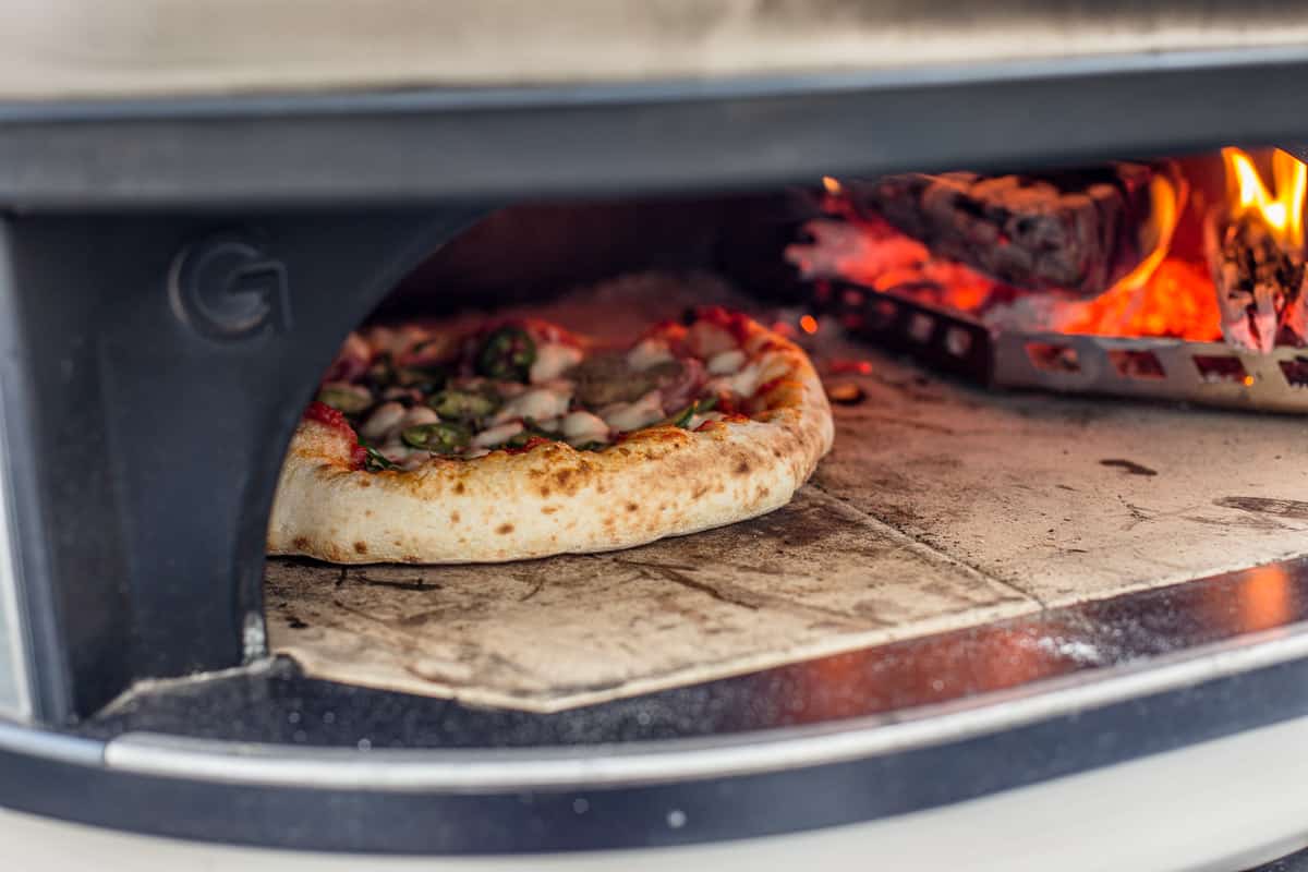 Jalapeño pizza cooking in a Gozney Dome pizza oven