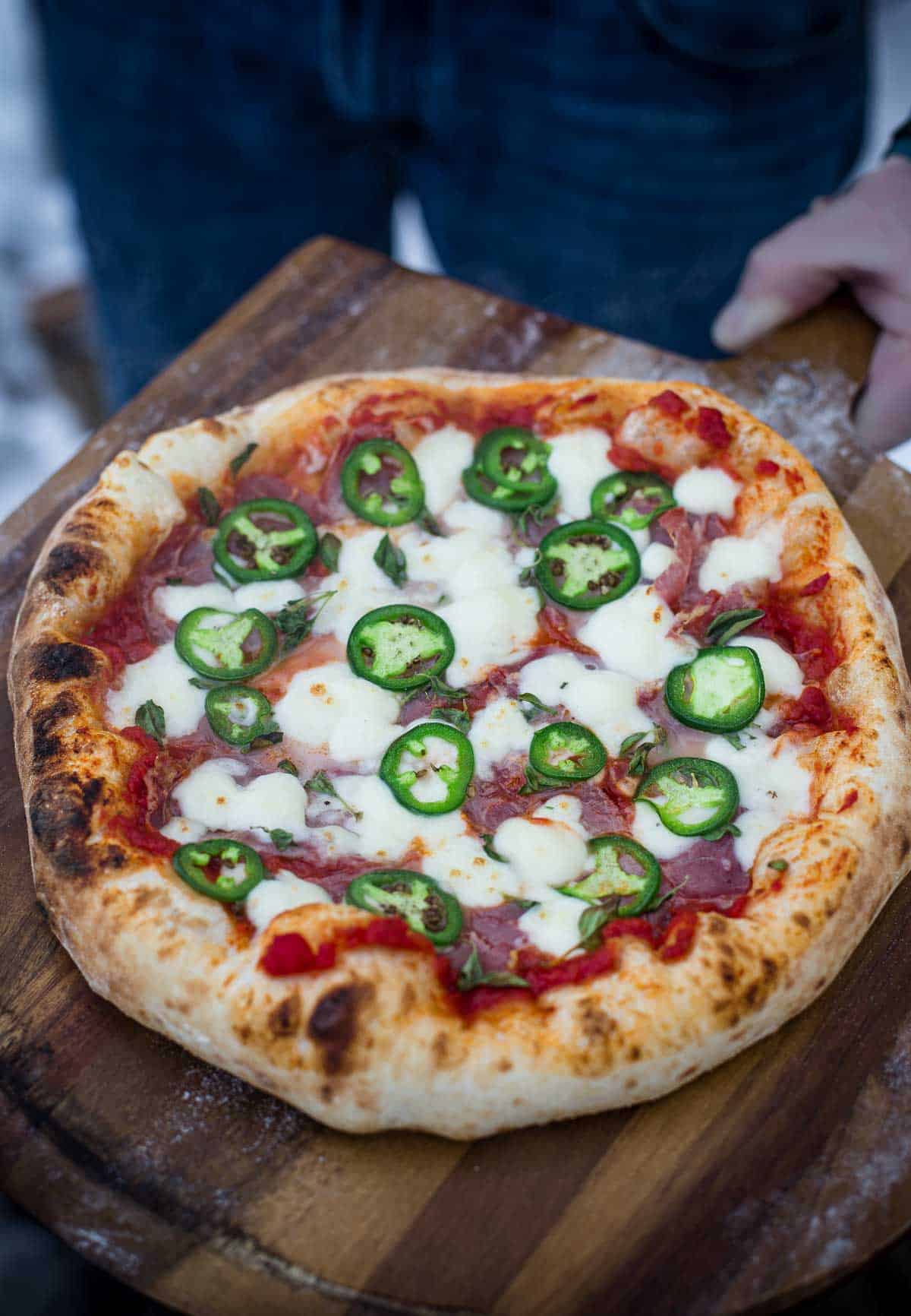 Neapolitan style pizza with jalapeño and copper on a cutting board