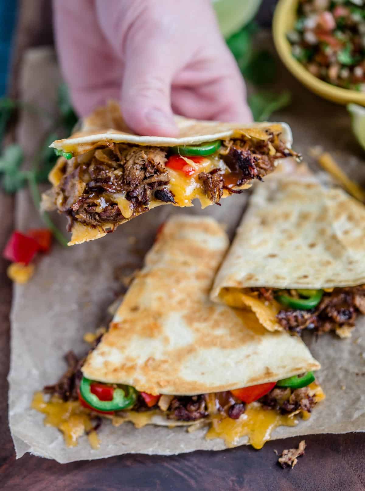 Holding beef quesadillas before eating.