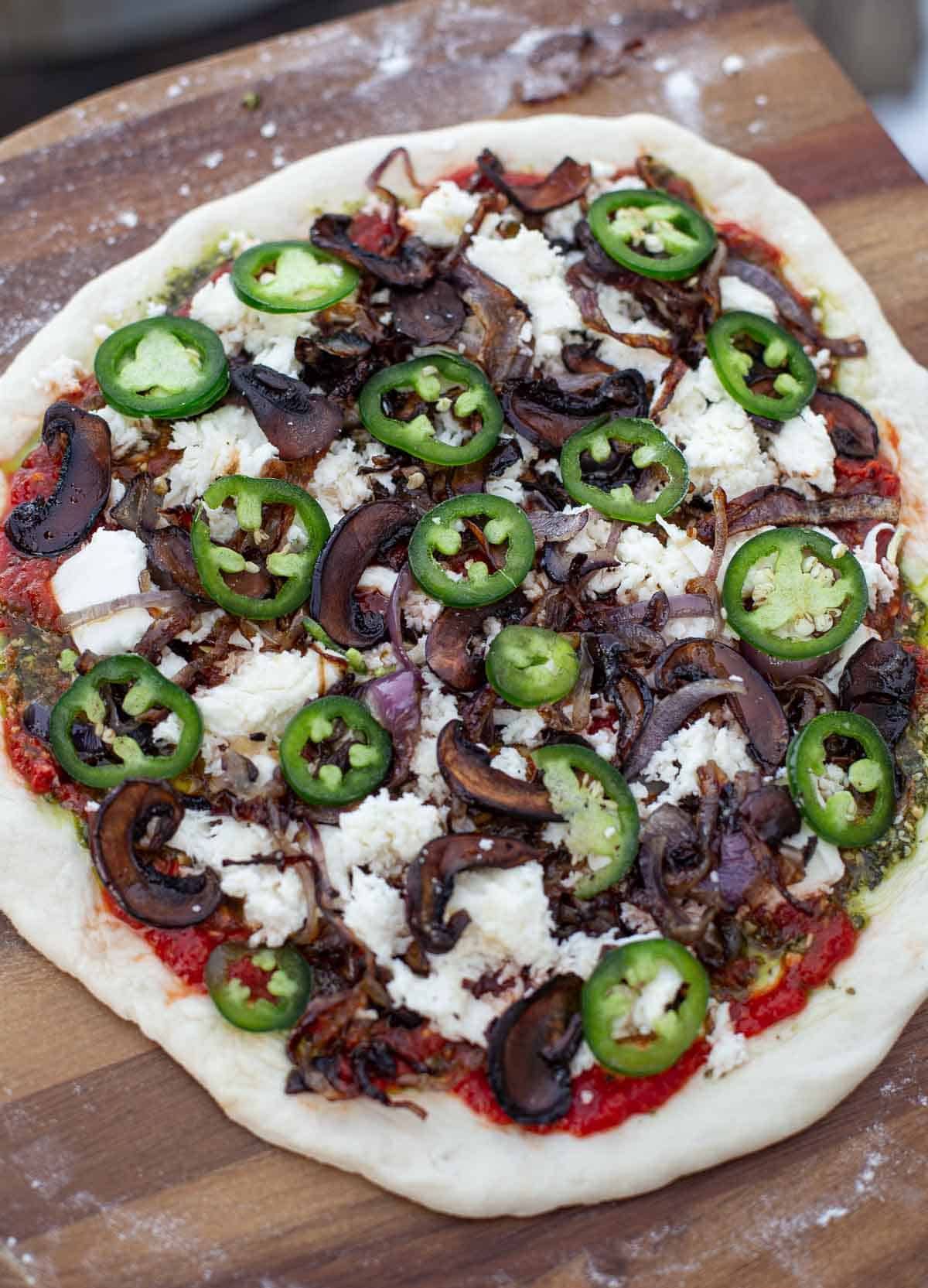 Vegetarian pizza loaded up and ready to go into the pizza oven.
