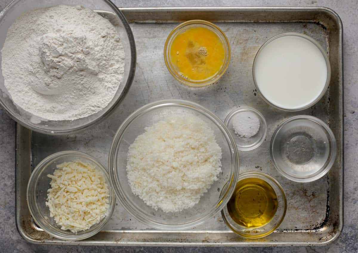 Ingredients for pao de queijo on a baking sheet