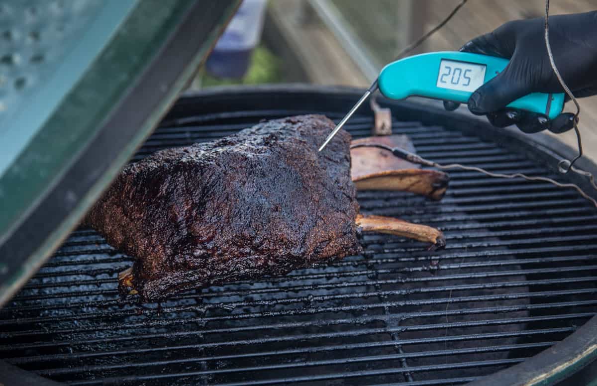 Smoked beef ribs with a digital instant read thermometer from thermoworks on a big green egg.