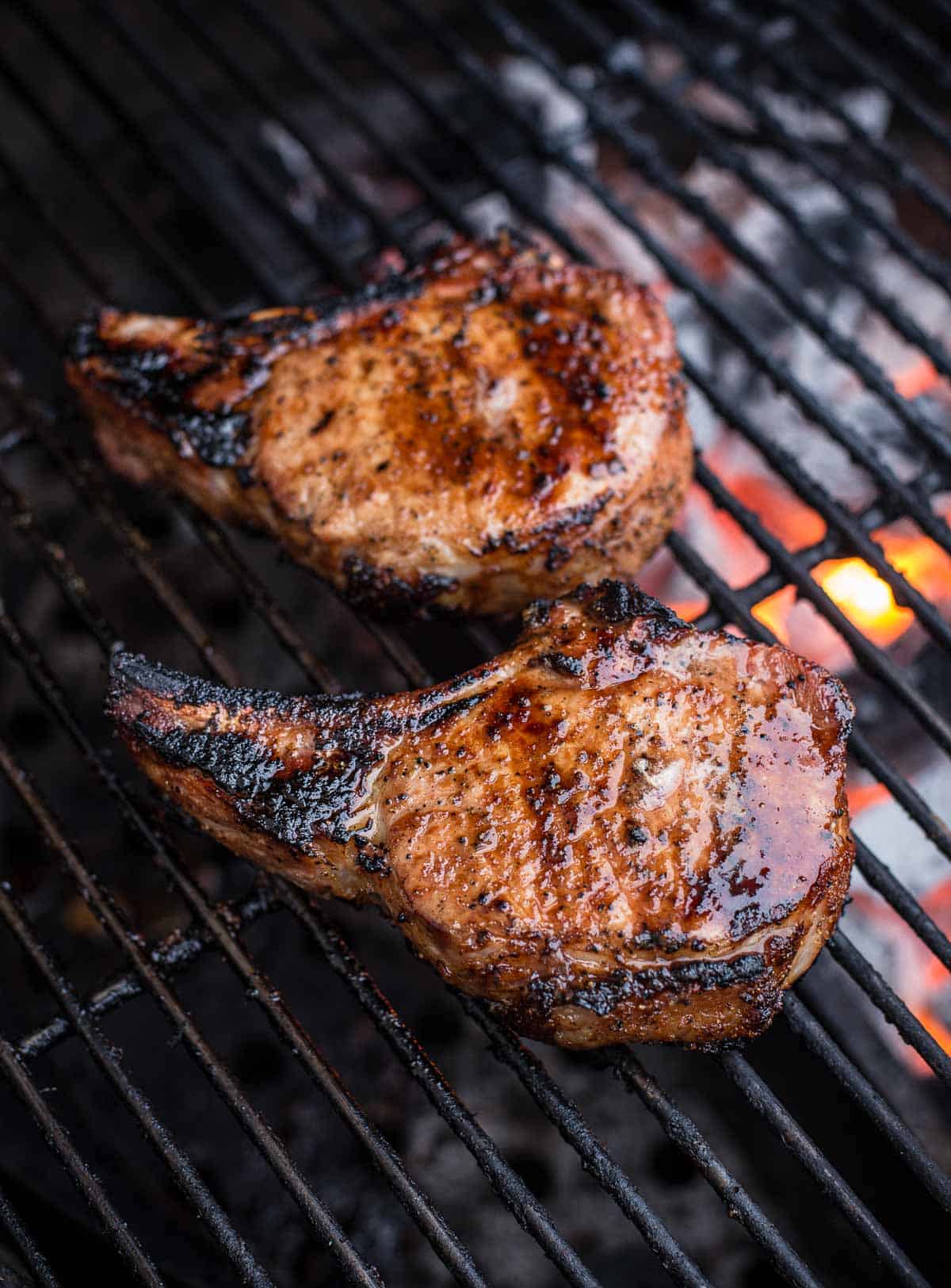 Grilled tomahawk pork chops over direct heat.