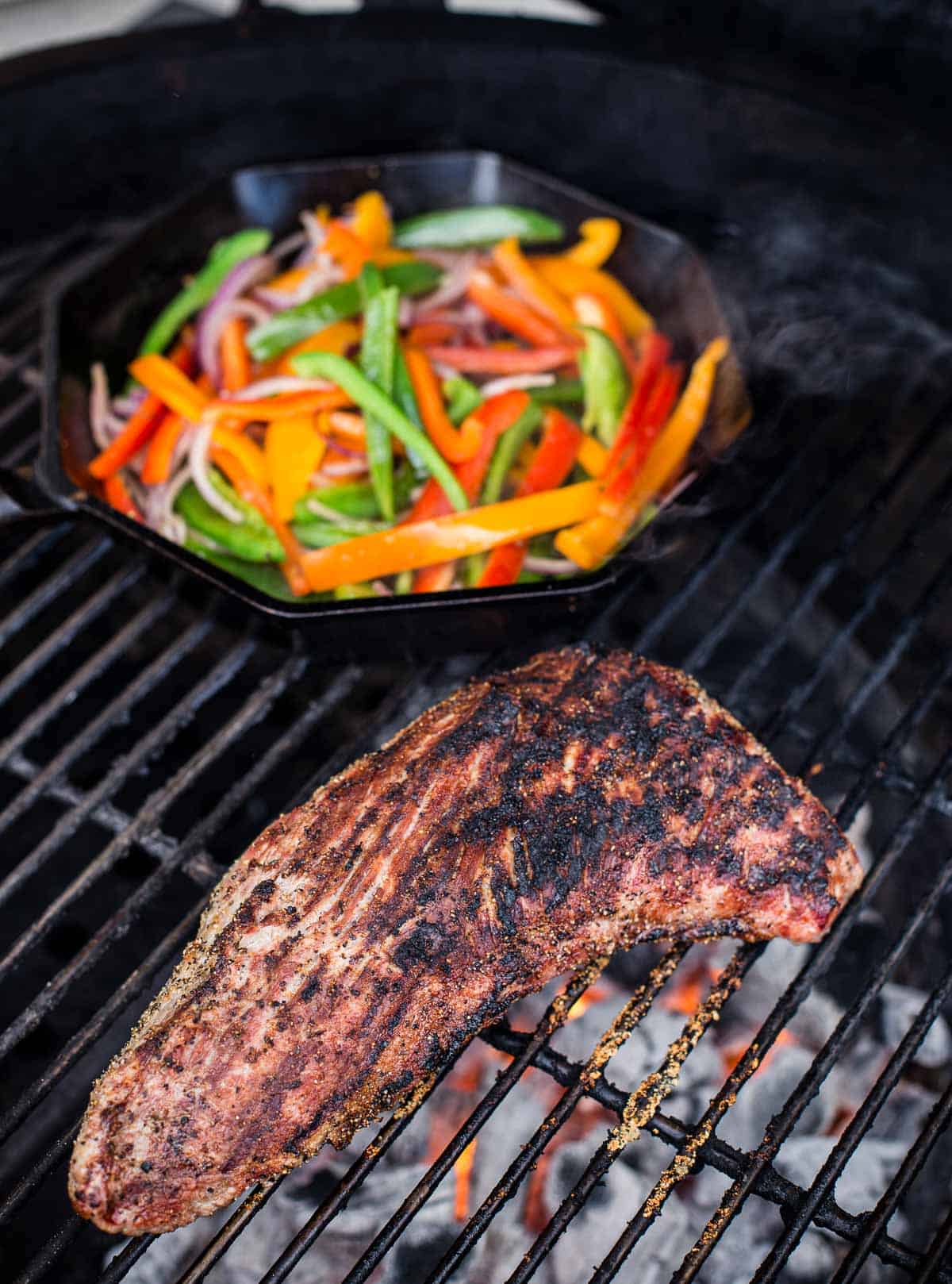 Tri tip and cast iron pan of onions and peppers for steak fajitas.